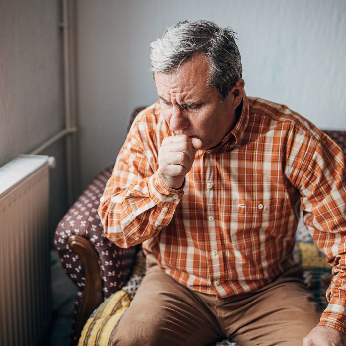 senior man coughing