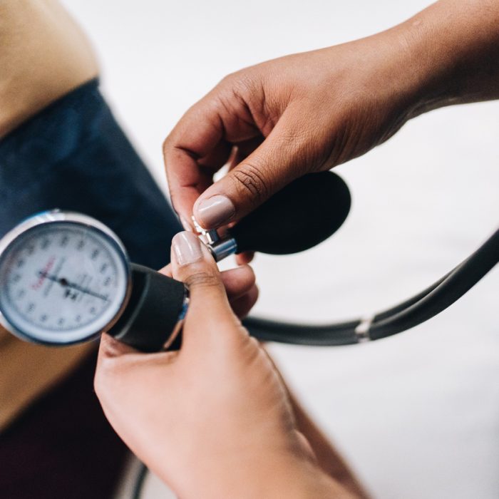 Nurse's hand taking blood pressure of a patient