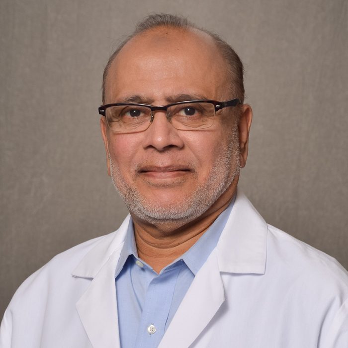 male physician wearing glasses and lab coat