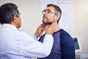 Doctor checking neck