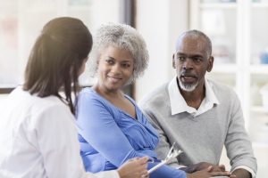 Couple speaking with physician