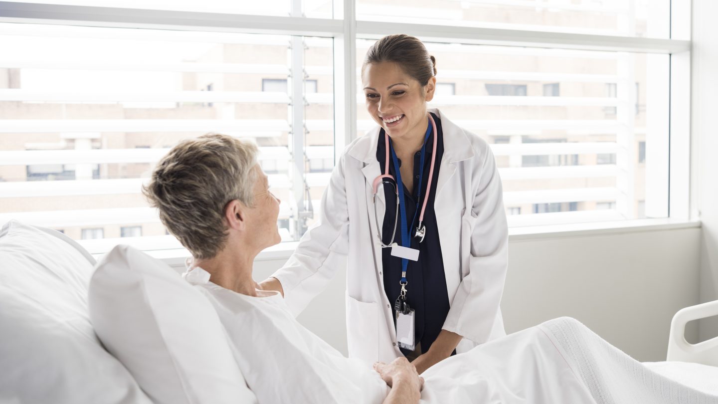 Female consultant smiling and talking with patient