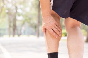 Man grasping leg