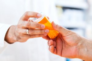 Pharmacist giving pills to customer