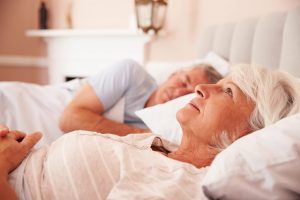 Worried Senior Woman Lying Awake In Bed