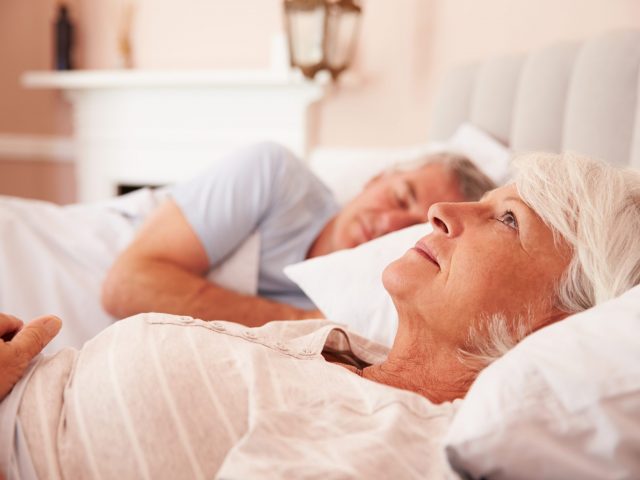 Worried Senior Woman Lying Awake In Bed