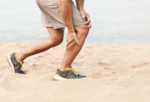 Man grabbing leg in pain