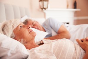Woman lying awake in bed