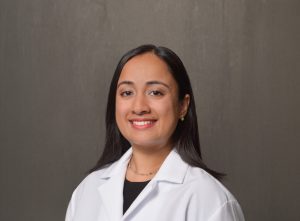 female physician with long dark hair and dark eyes