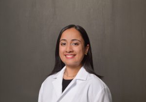 female physician with long dark hair and dark eyes