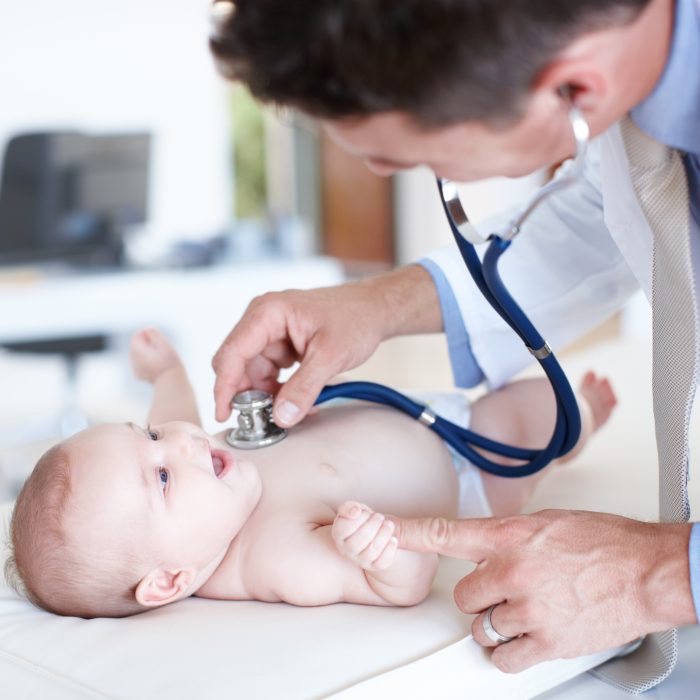 Pediatrician examines baby's chest.