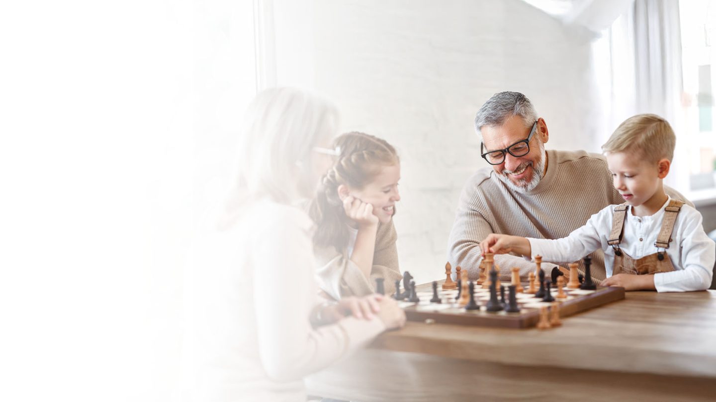Man playing chess with son.