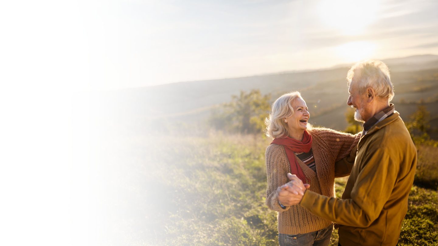 Senior Couple dancing on hillside