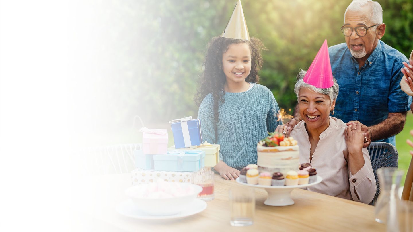 Woman with family celebrating birthday